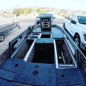 Dark gray 20 oz. marine grade premium boat carpet installed on a bass boat deck with open storage compartments.