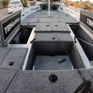 Gray 20 oz. premium cut pile marine carpet installed on a boat deck, showing storage compartments.
