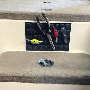 Black textured Magnalure Pad with fishing pliers, yellow and red lures, and a snip tool attached to a boat console.