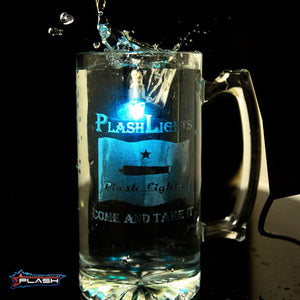 PlashLights RGB LED step light in stainless housing submerged in a clear glass mug with water splashing.