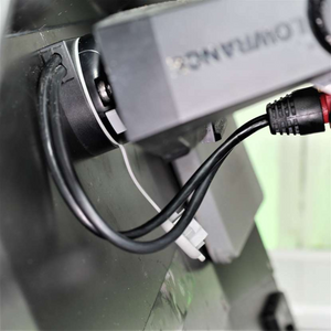Black Railblaza E Series Cable Entry Port Base with cables neatly routed, mounted on a dark surface.