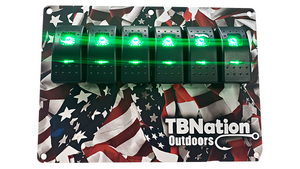 TBNation 6-gang rocker switch panel with green illuminated switches on an American flag hydro-dipped aluminum plate.