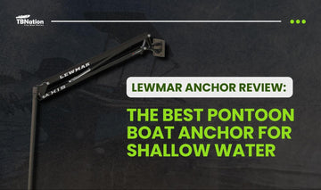 A pontoon boat anchored securely in shallow water using a Lewmar anchor, with calm conditions and clear skies, illustrating effective anchoring performance near the shoreline.