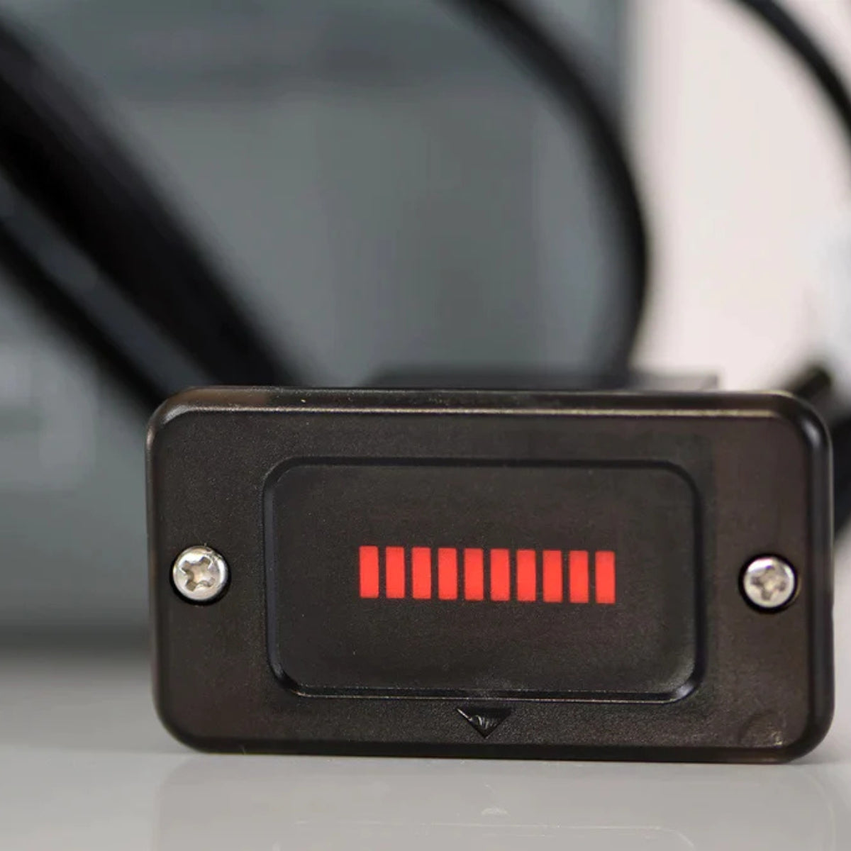 Black rectangular battery indicator with red LED bars showing charge level.