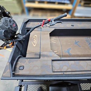Custom 1436 duck boat with espresso over black paint, camo HydroTurf, and a mud motor.