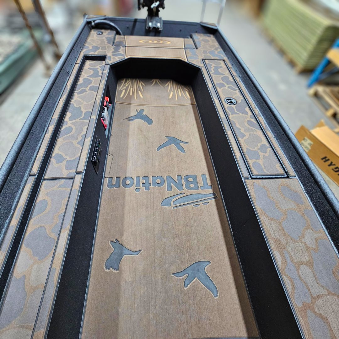 Custom 1436 duck boat deck with espresso over black camo HydroTurf, laser-engraved ducks, and "TBNation" logo.