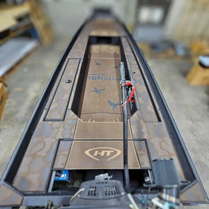 Custom 1436 duck boat with espresso over black paint, camo HydroTurf, and mud motor.