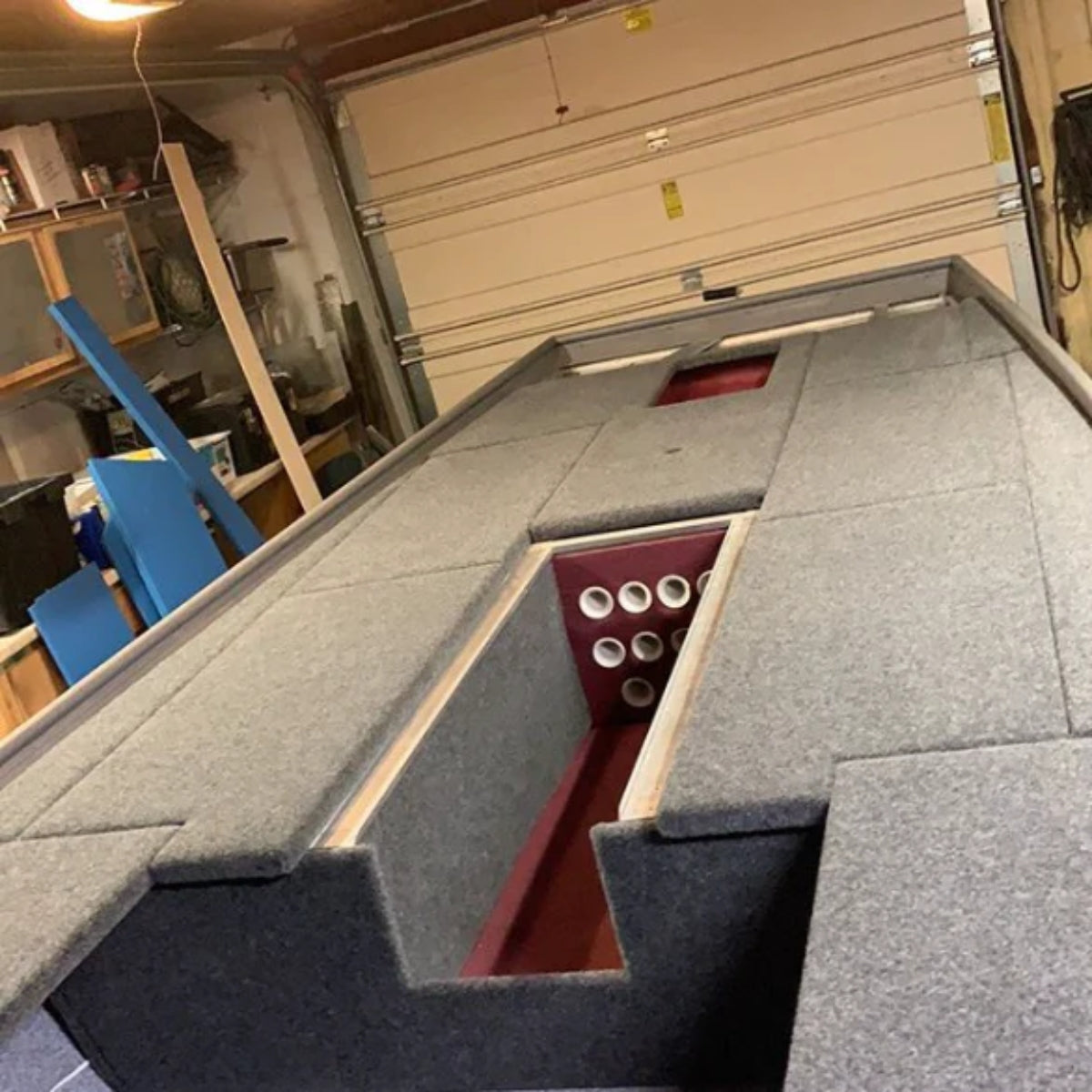 Charcoal 16 oz. cut pile marine grade boat carpet installed on a jon boat deck with storage.
