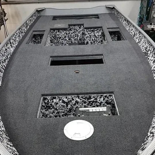 Dark gray 20 oz marine grade premium boat carpet installed in a boat deck, with black and white camouflage accents.