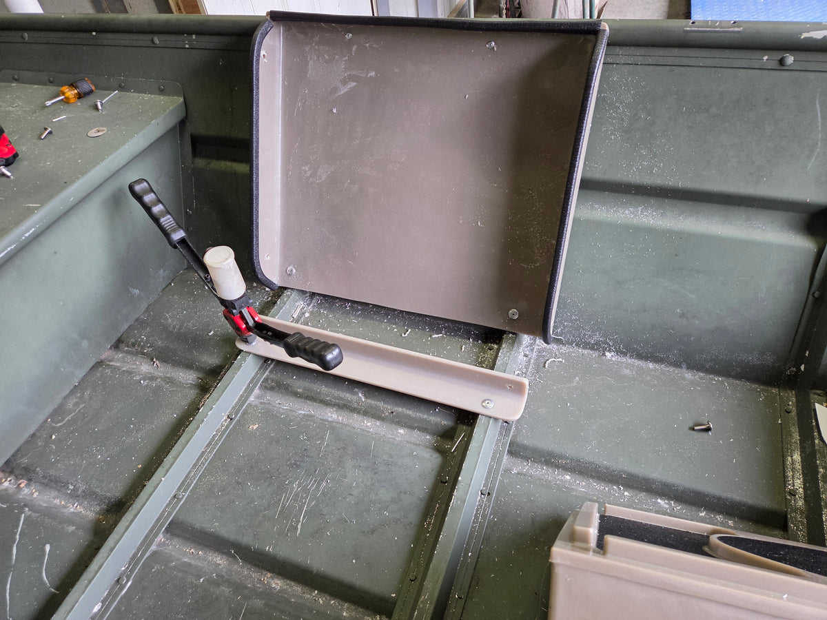 Tan Universal Jon Boat Tiller Console with angled back, mounted in a green aluminum jon boat.