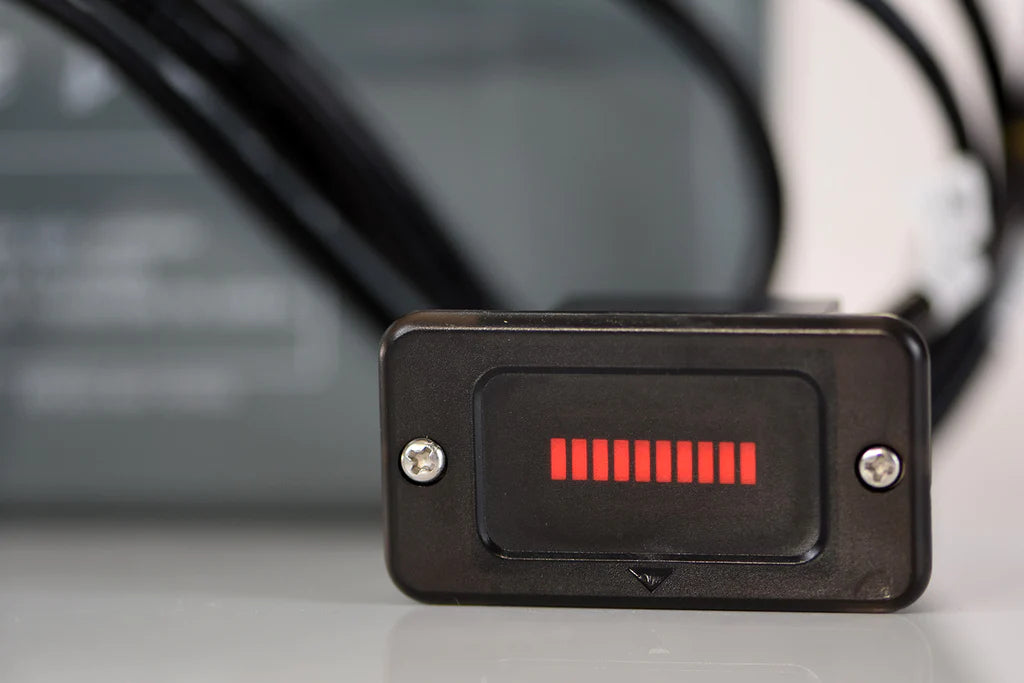 Close-up of a black rectangular battery indicator with red bars, showing charge level.