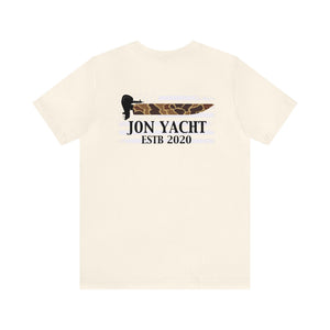 Light cream unisex t-shirt with "JON YACHT ESTB 2020" text and a boat motor graphic.