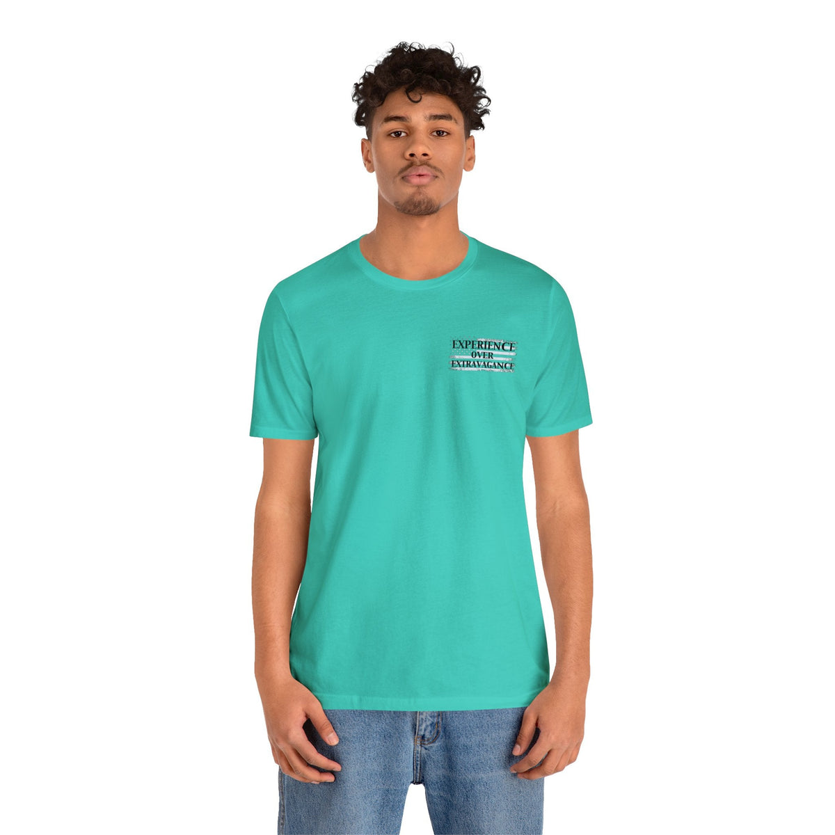 Man in a teal "American Dreamer" t-shirt with "EXPERIENCE OVER EXTRAVAGANCE" text on the chest.