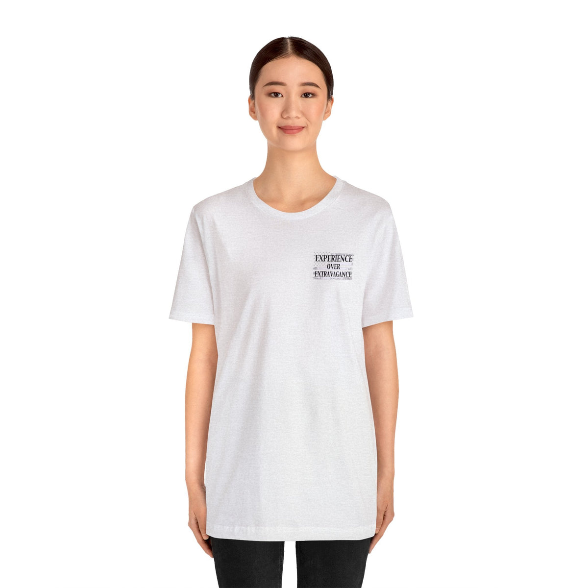 Woman wearing a white unisex jersey short sleeve tee with "EXPERIENCE YOUR EXTRAVAGANCE" text.