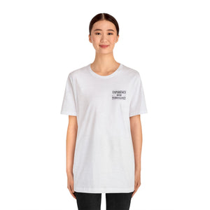 Woman wearing a white unisex jersey short sleeve tee with "EXPERIENCE YOUR EXTRAVAGANCE" text.