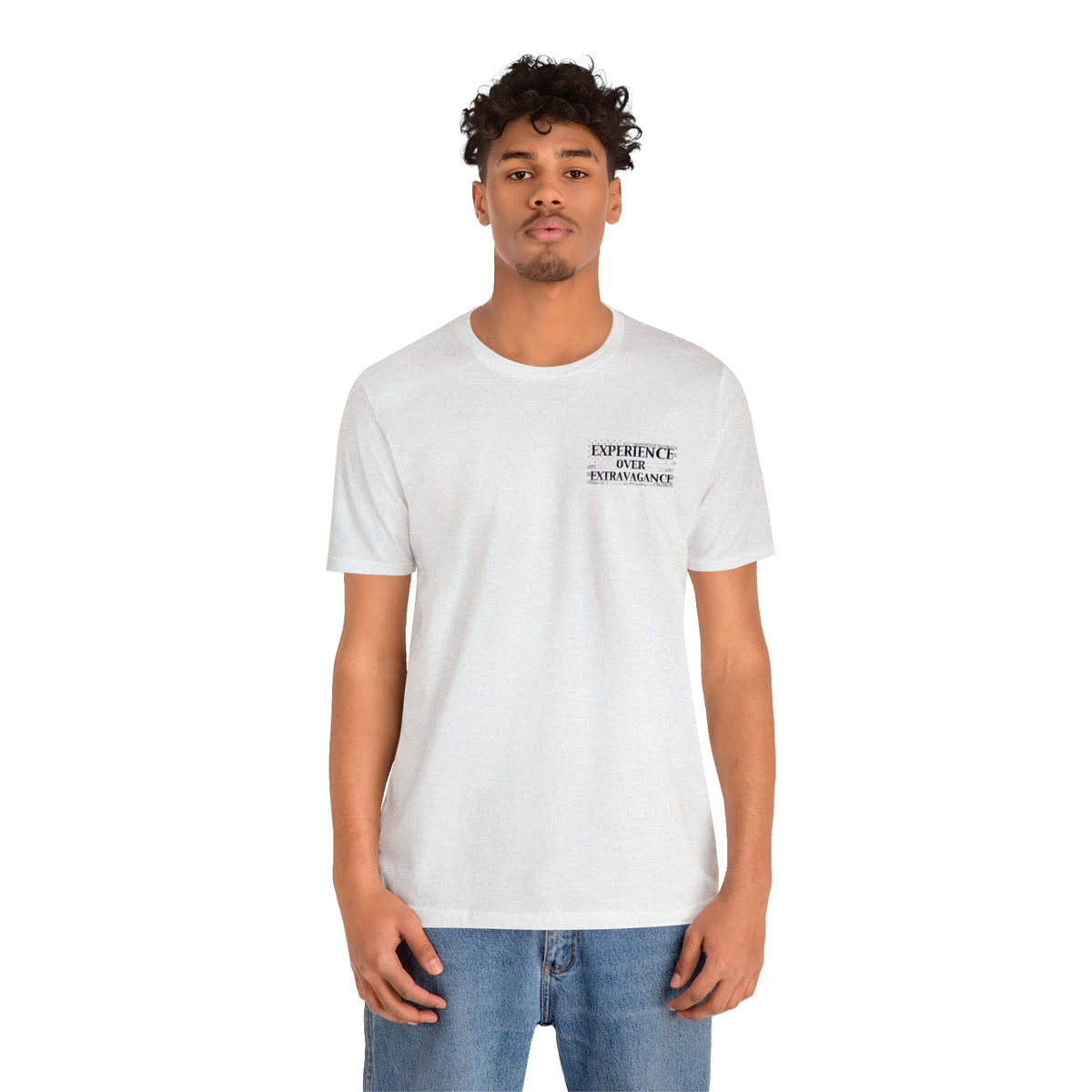 Man in a light gray unisex jersey tee with "EXPERIENCE OVER EXTRAVAGANCE" text on the left chest.