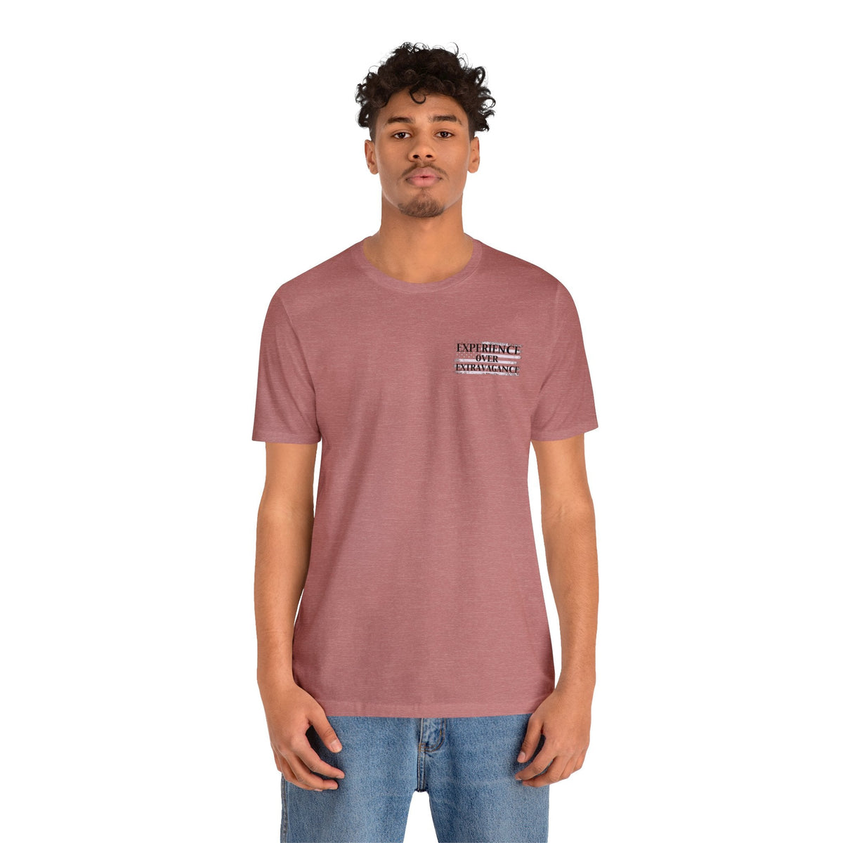 Man in a heather mauve "American Dreamer" t-shirt with "EXPERIENCE OVER EXTRAVAGANCE" text on the chest.