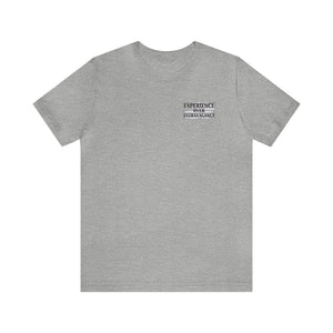 Gray unisex jersey t-shirt with "EXPERIENCE OVER EXTRAVAGANCE" text on the left chest.