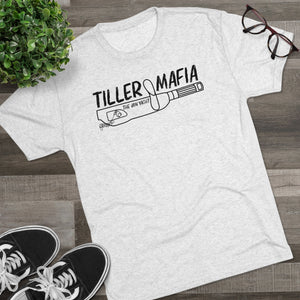 Light grey tri-blend tee with "TILLER MAFIA THE JON YACHT" graphic, black sneakers, and glasses.