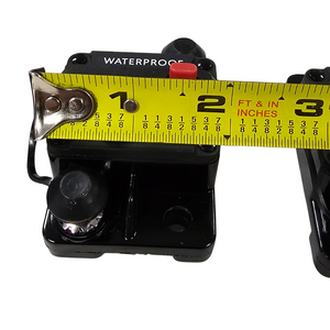 Black waterproof circuit breaker for trolling motors, 1-7/8" wide, with red reset button.