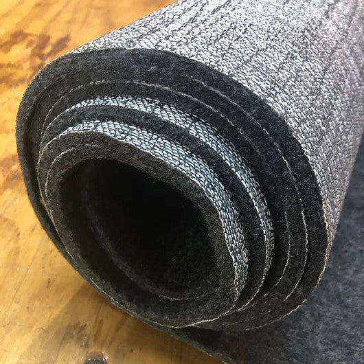 Rolled DuraVinyl Ridgeline Series marine flooring, showing its woven silver-grey surface and dark felt backing.