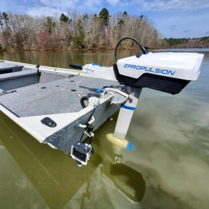 A boat equipped with an EPropulsion Spirit 1.0 Plus 3HP electric outboard motor floating on the water. 