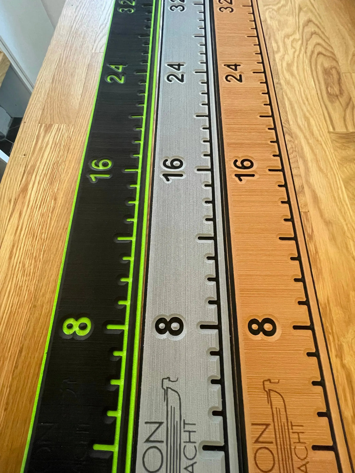 Three 38 1/4" x 4" fish ruler pads in black, grey, and tan with green, black, and black markings.