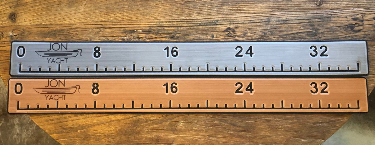 Two 38 1/4" x 4" ruler pads, one silver and one bronze, with "JON YACHT" logo and measurements.