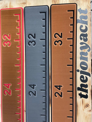 Three 38 1/4" x 4" ruler pads with adhesive backing in brown with pink trim, gray, and brown with black trim, showing measurements 24 and 32.