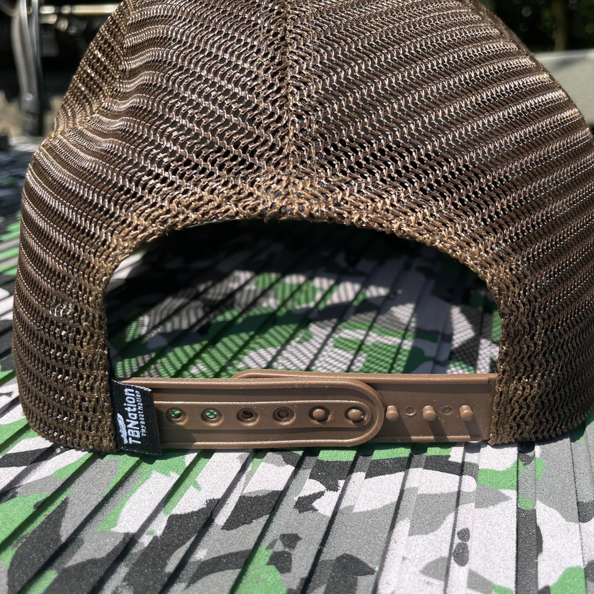 Brown mesh trucker hat with a snapback closure and "TBNation" tag.