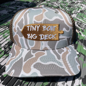 Camo "Tiny Boat Big Deck" hat with brown mesh back and embroidered boat patch.