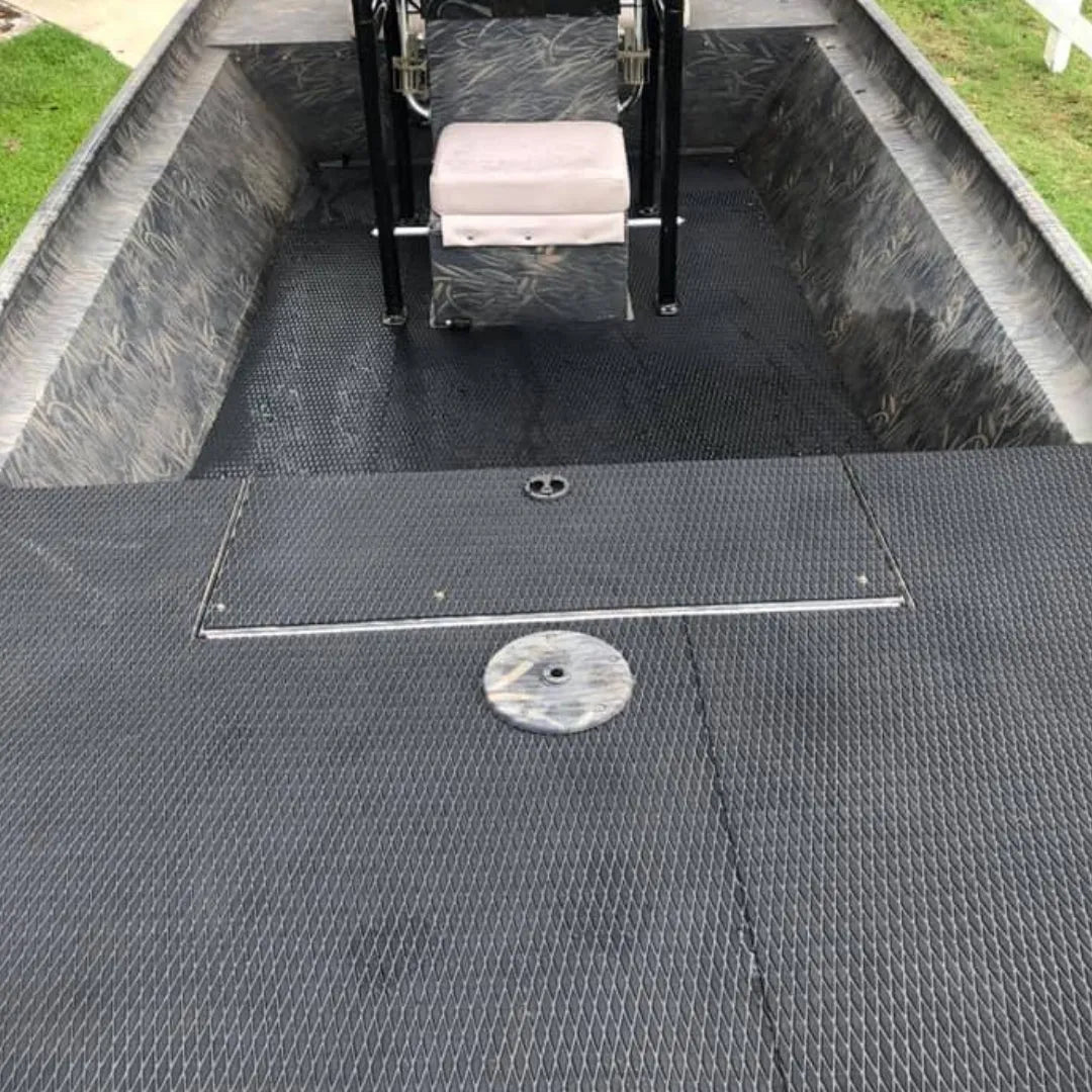 Black Hydro-Turf EVA foam traction mat with molded diamond cut pattern installed in a jon boat.