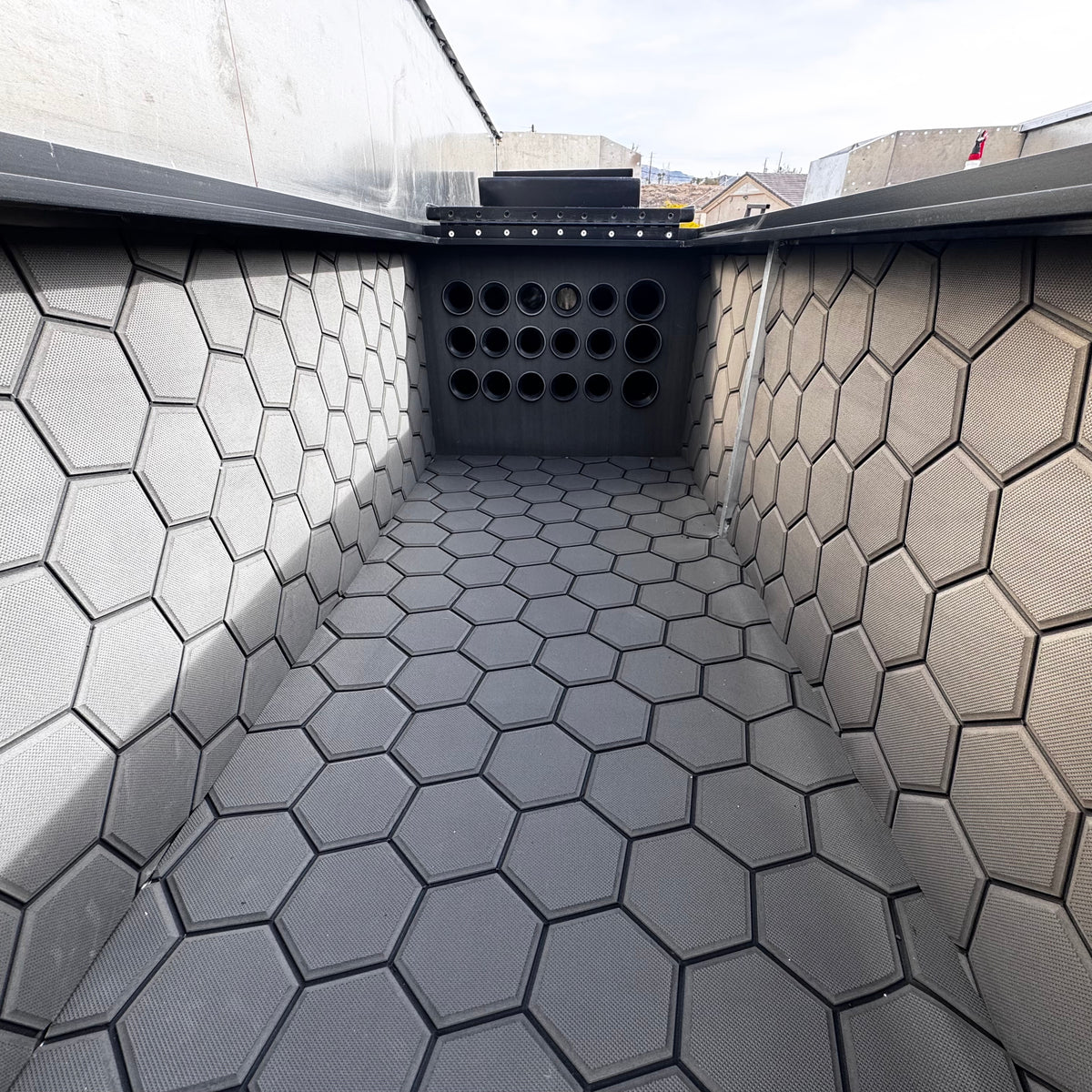 Dark gray Hydro Turf Pro Series EVA foam matting with a textured hexagonal pattern lining a boat interior.