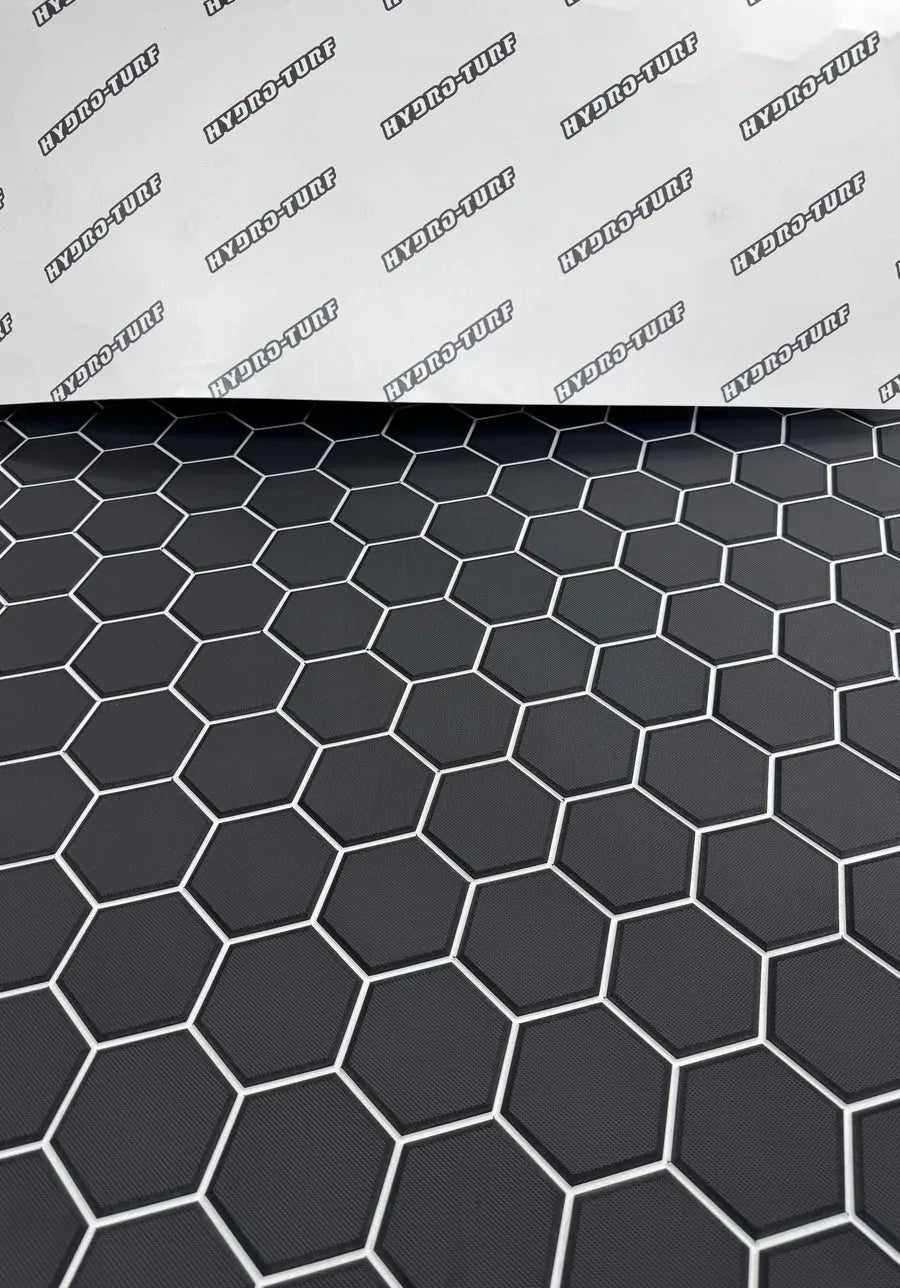 Dark gray Hydro Turf Pro Series EVA foam matting with a textured hexagonal pattern lining a boat interior.