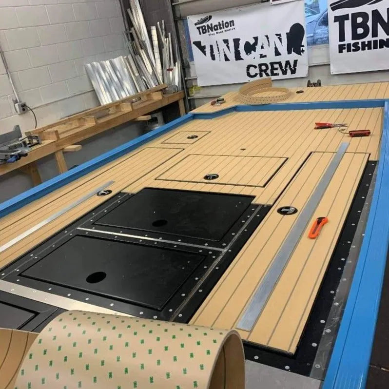 Hydro-turf 2-tone wide groove teak cut marine flooring installed on a boat deck.