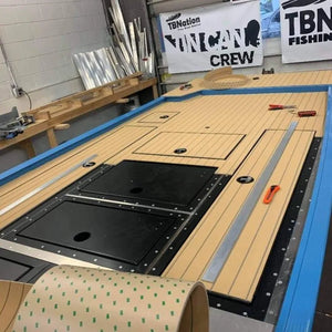 Hydro-turf 2-tone wide groove teak cut marine flooring installed on a boat deck.