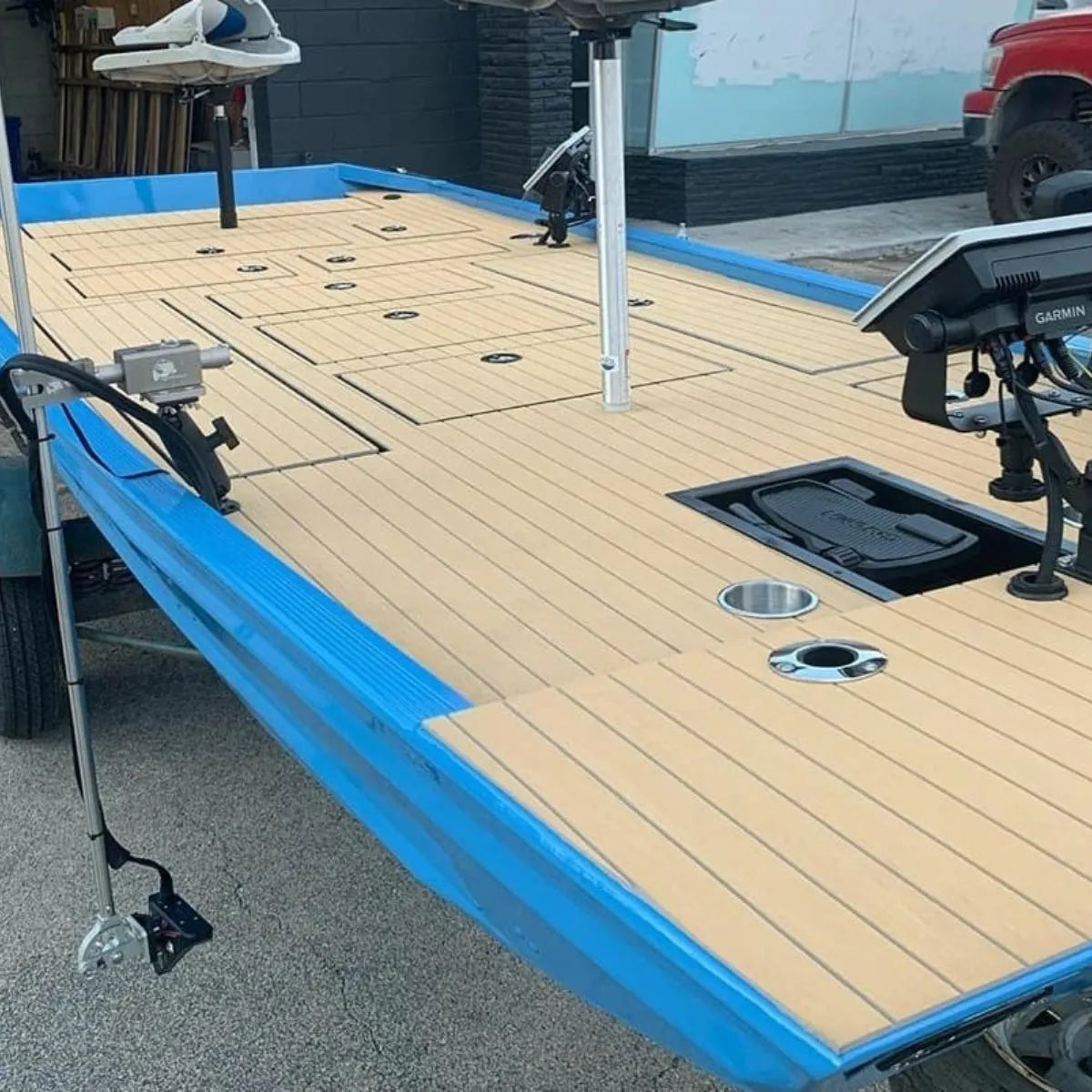 Blue boat deck with 2-tone wide groove teak cut Hydro-turf, showing a light brown textured surface.