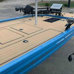 Blue boat deck with tan, wide groove teak-look Hydro-turf flooring, showing storage hatches and marine electronics.