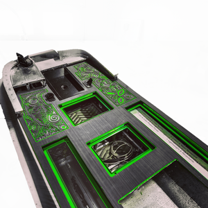 HydroTurf two-tone EVA foam decking sheets, black with bright green routed designs, installed on a boat deck.