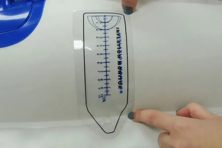 Clear plastic inflation gauge with black "INFLATION MONITOR" text and a 10cm ruler for kayaks.