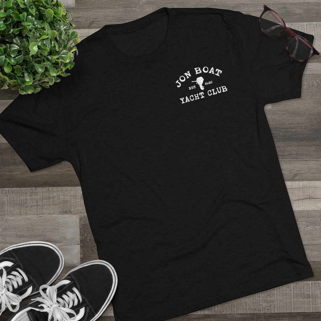 Black tri-blend tee with white "Jon Boat Yacht Club" logo, styled with sneakers and glasses.