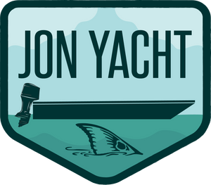 Jon Yacht Tailer 4" sticker: teal, light blue, and dark green design with a boat, outboard motor, and shark fin.