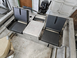 Two aluminum JumpSeat flip-up stowable seats with black vinyl cushions installed in a boat.