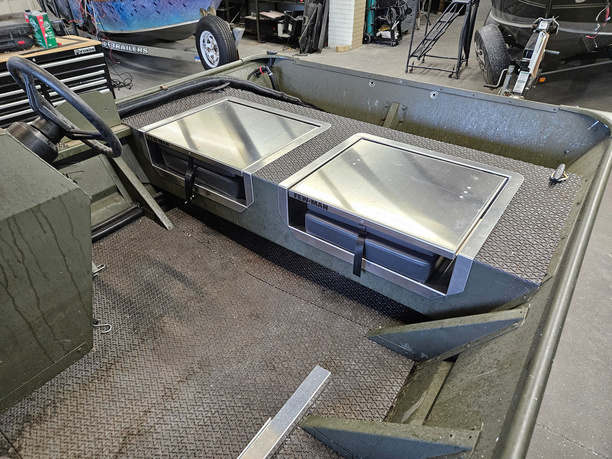 Two silver Few-Man JumpSeats installed in an olive green boat, featuring flip-up lids and black latches.