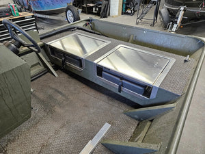 Two silver Few-Man JumpSeats installed in an olive green boat, featuring flip-up lids and black latches.