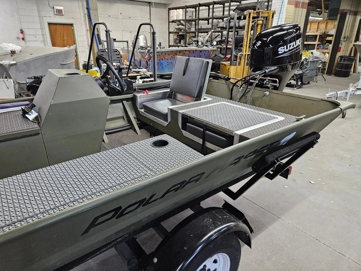 Olive green boat interior with a flip-up stowable seat and textured gray EVA foam flooring.