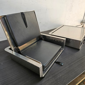 Silver aluminum JumpSeat with black vinyl cushions, one open and one closed.