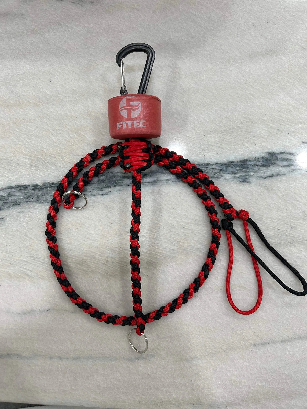 Red and black braided paracord key lanyard with a red float, black carabiner, and kill switch.