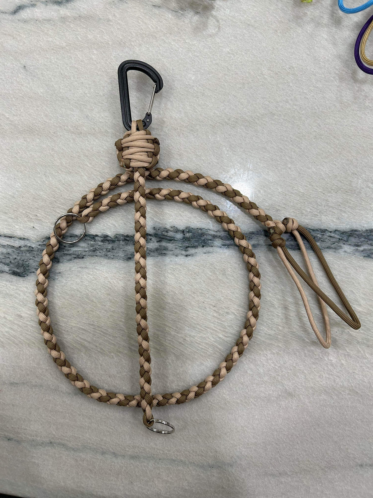 Braided tan and brown paracord key lanyard with a black carabiner and metal kill switch clip.