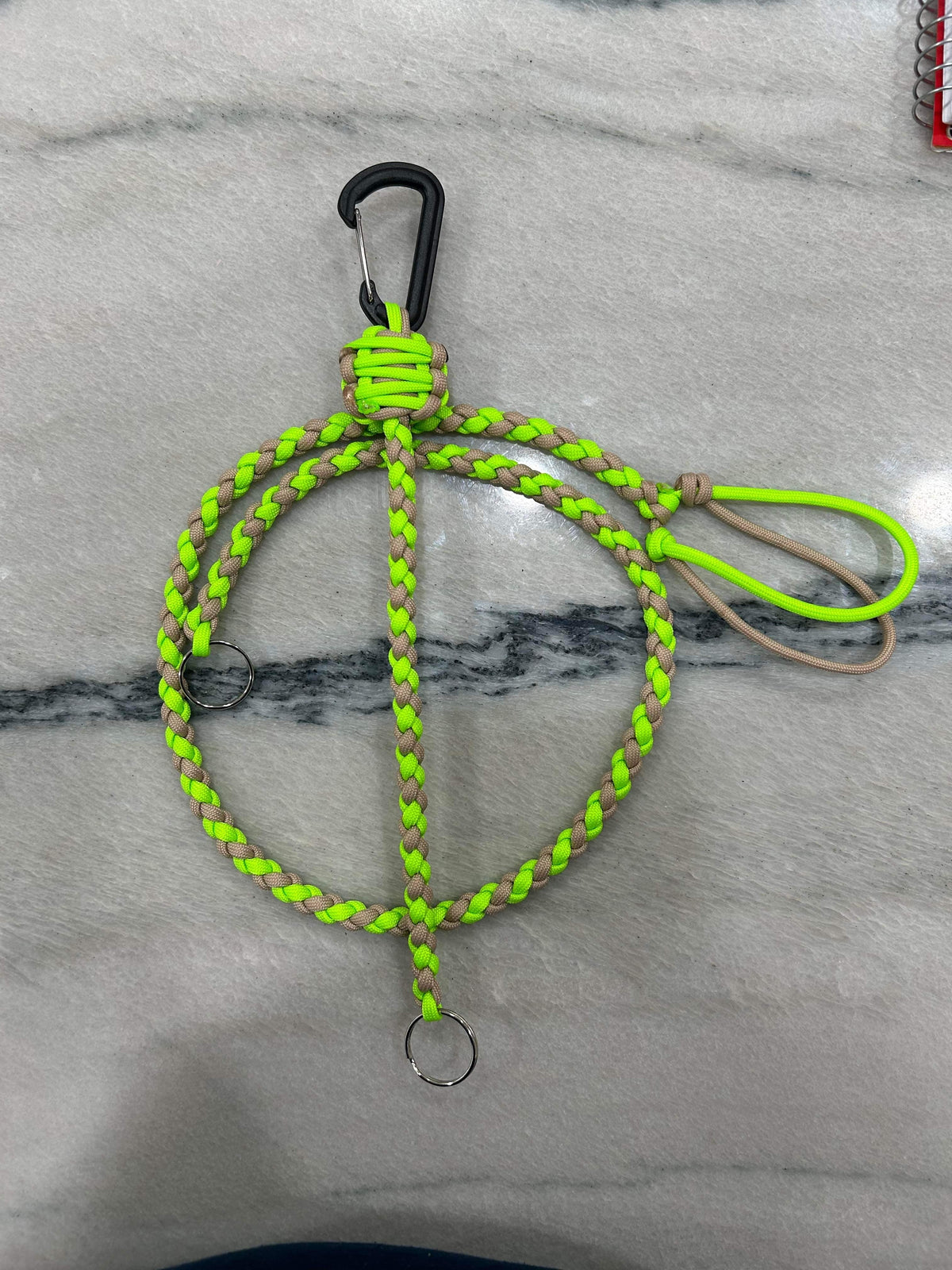 Neon green and tan braided paracord key lanyard with a black carabiner and two metal keyrings.